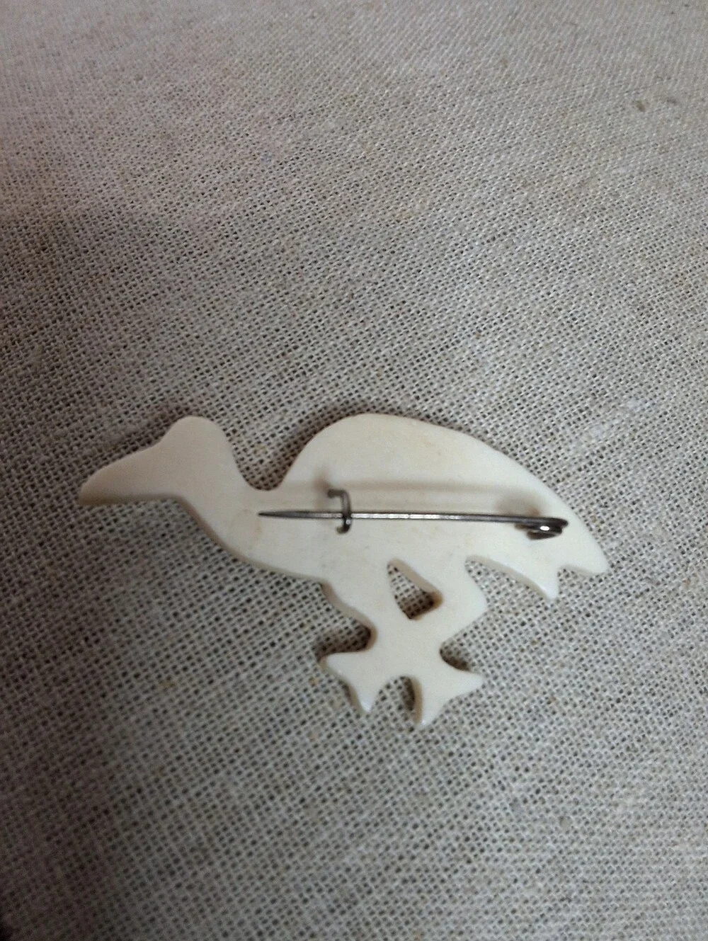 “Vintage hand-carved ivory-tone bird brooch, likely bone; material untested.”